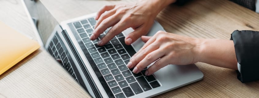 Older woman's hands on keyboard, aging hands